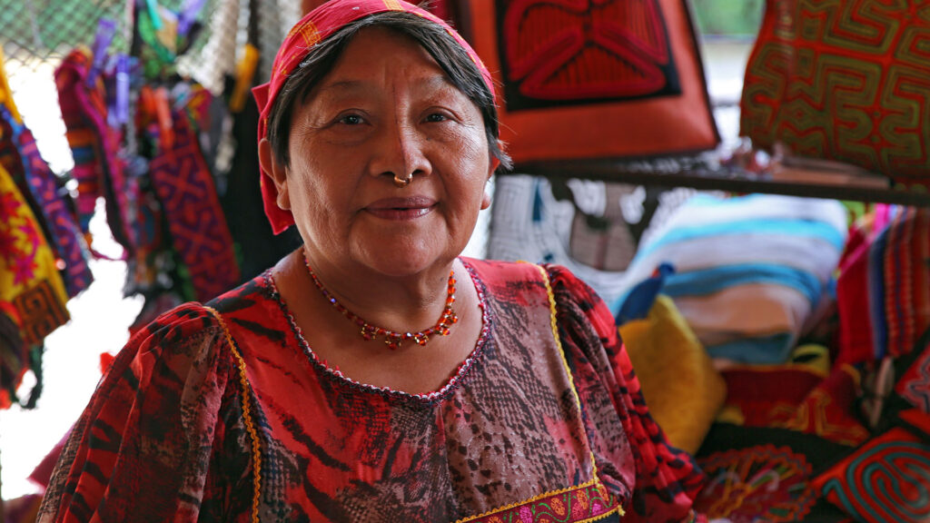 Vibrant Kuna artist showcasing handmade tribal art and crafts, rich with colour and tradition