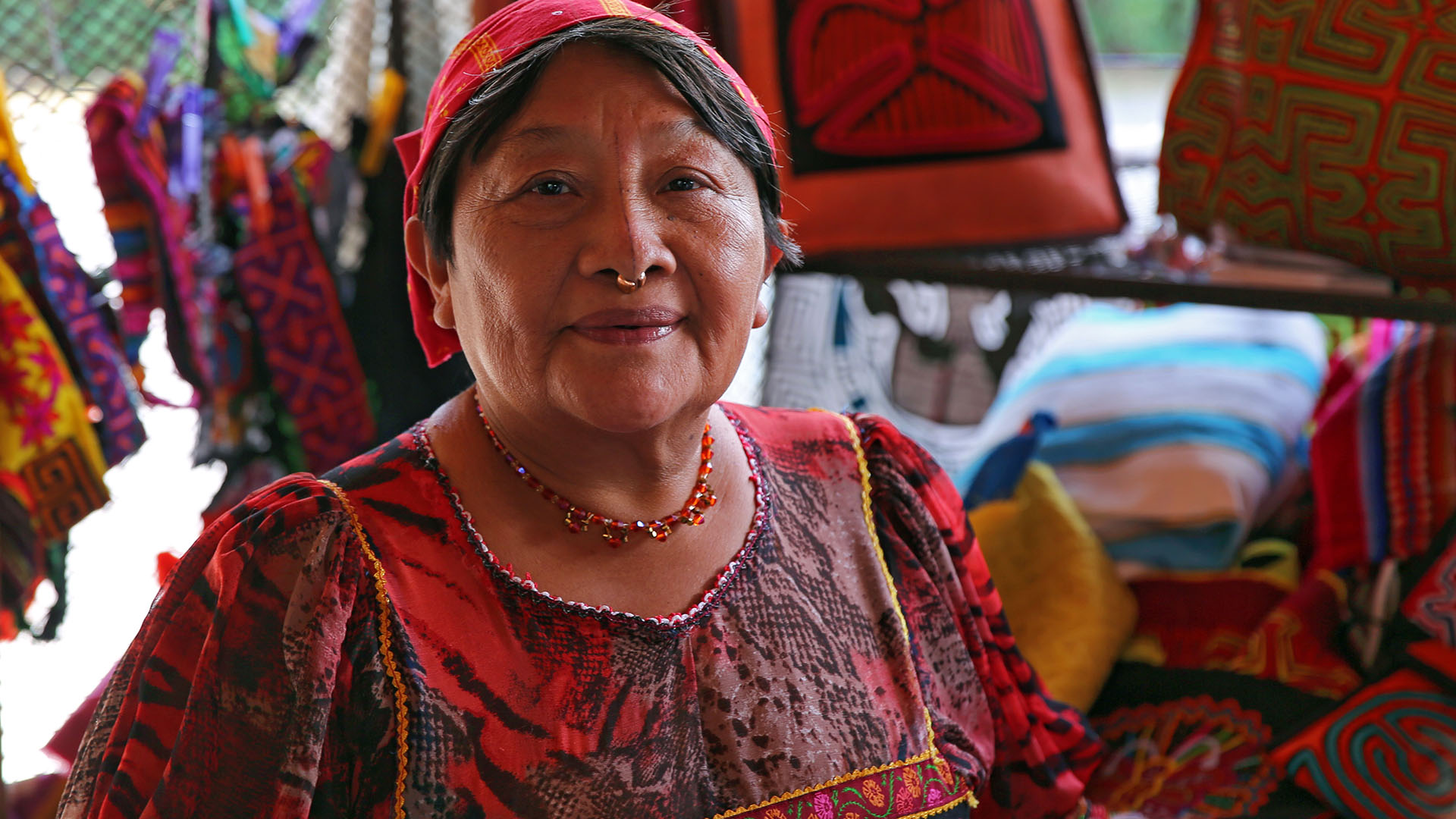 Vibrant Kuna artist showcasing handmade tribal art and crafts, rich with colour and tradition