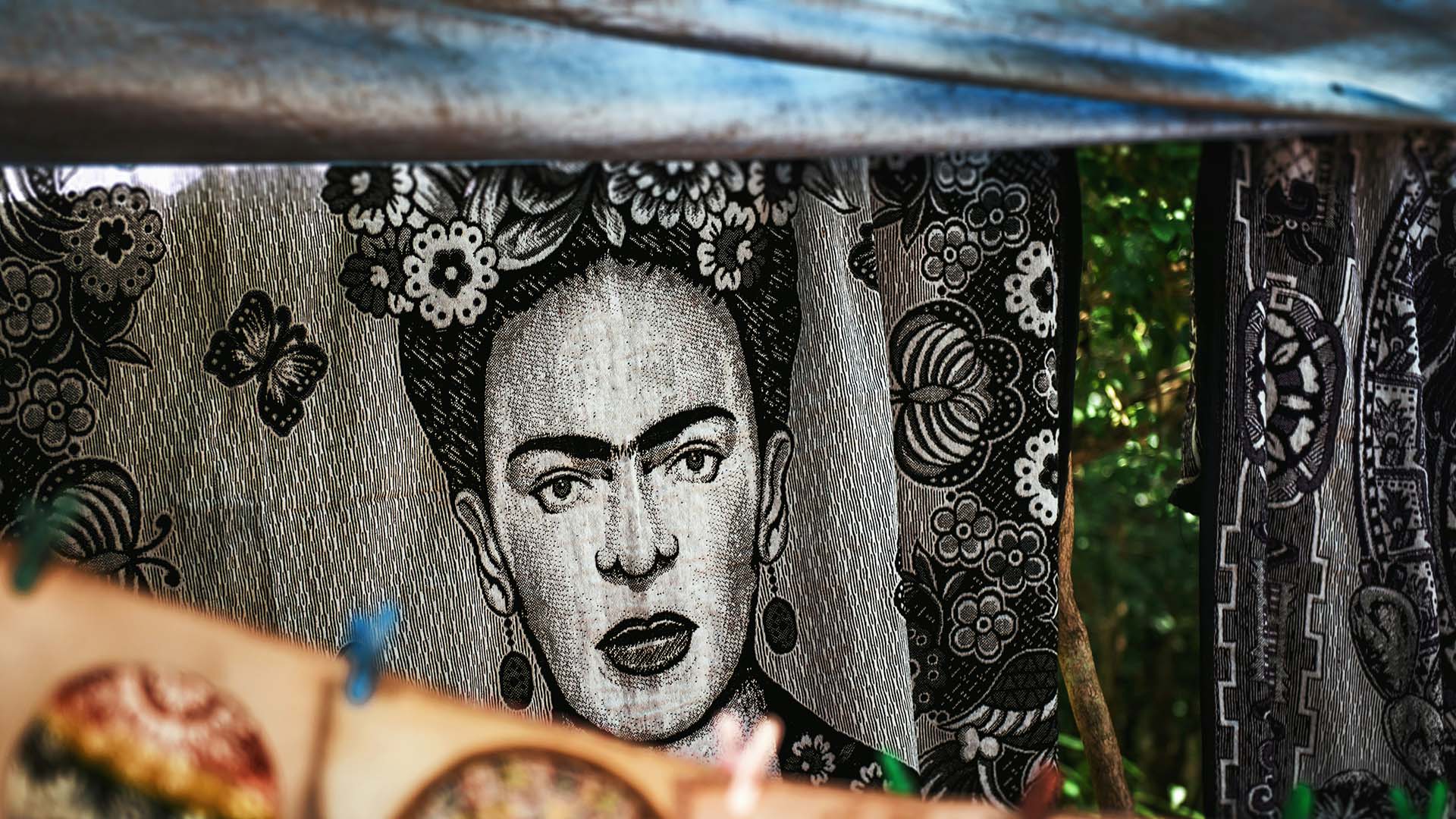 Frida Kahlo–inspired tapestry woven into a portrait celebrating resilience, identity, and Mexican folk art